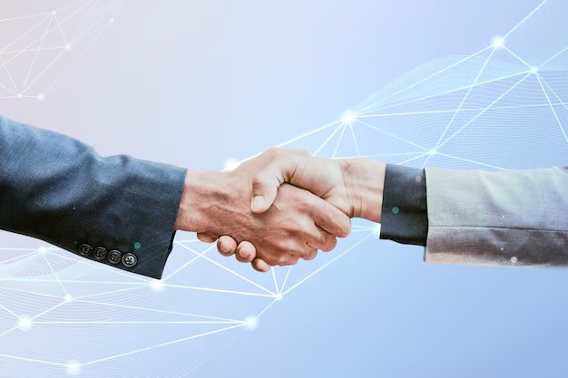 Two business professionals shaking hands, representing a technology partnership